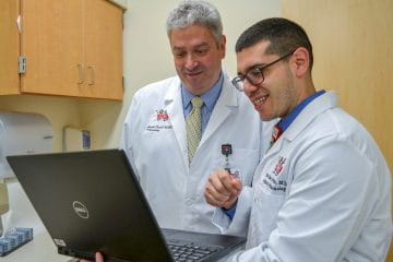 Two providers looking at a computer