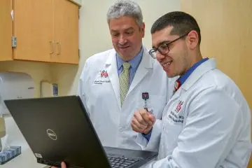 Two providers looking at a computer