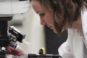 Person looking at a microscope