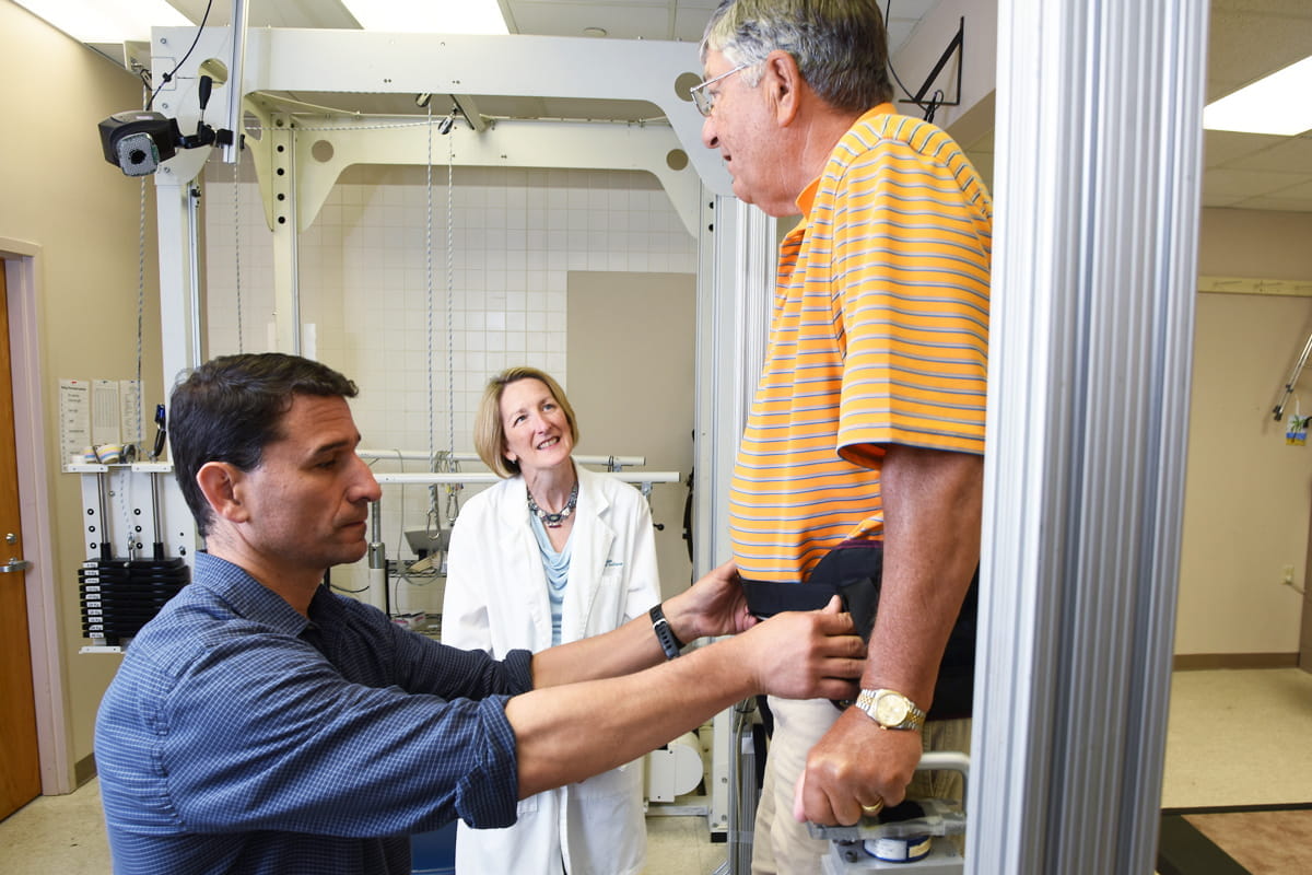 Flora Hammond and George Hornby work with a patient in the locomotor recovery center