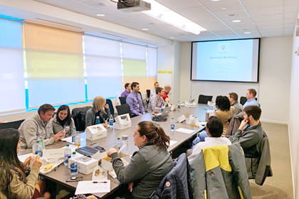 faculty and fellows attend a workshop