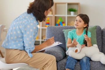 A child psychiatrist meets with a pediatric patient