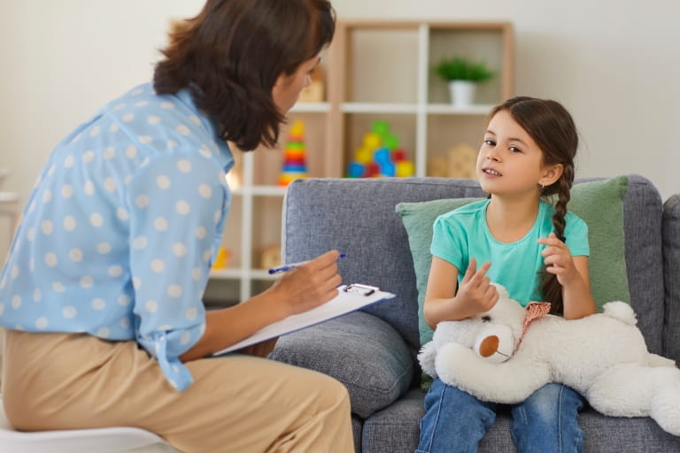 A psychiatrist meets with a pediatric patient.