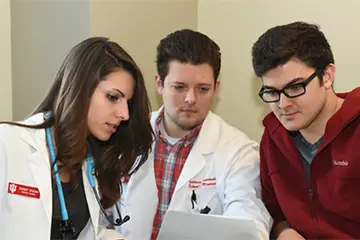three physicists review clinical data together
