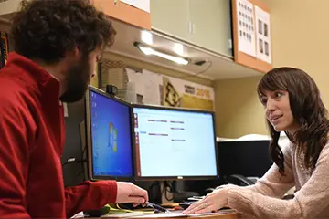 two physicists discuss a treatment plan in a clinical work space