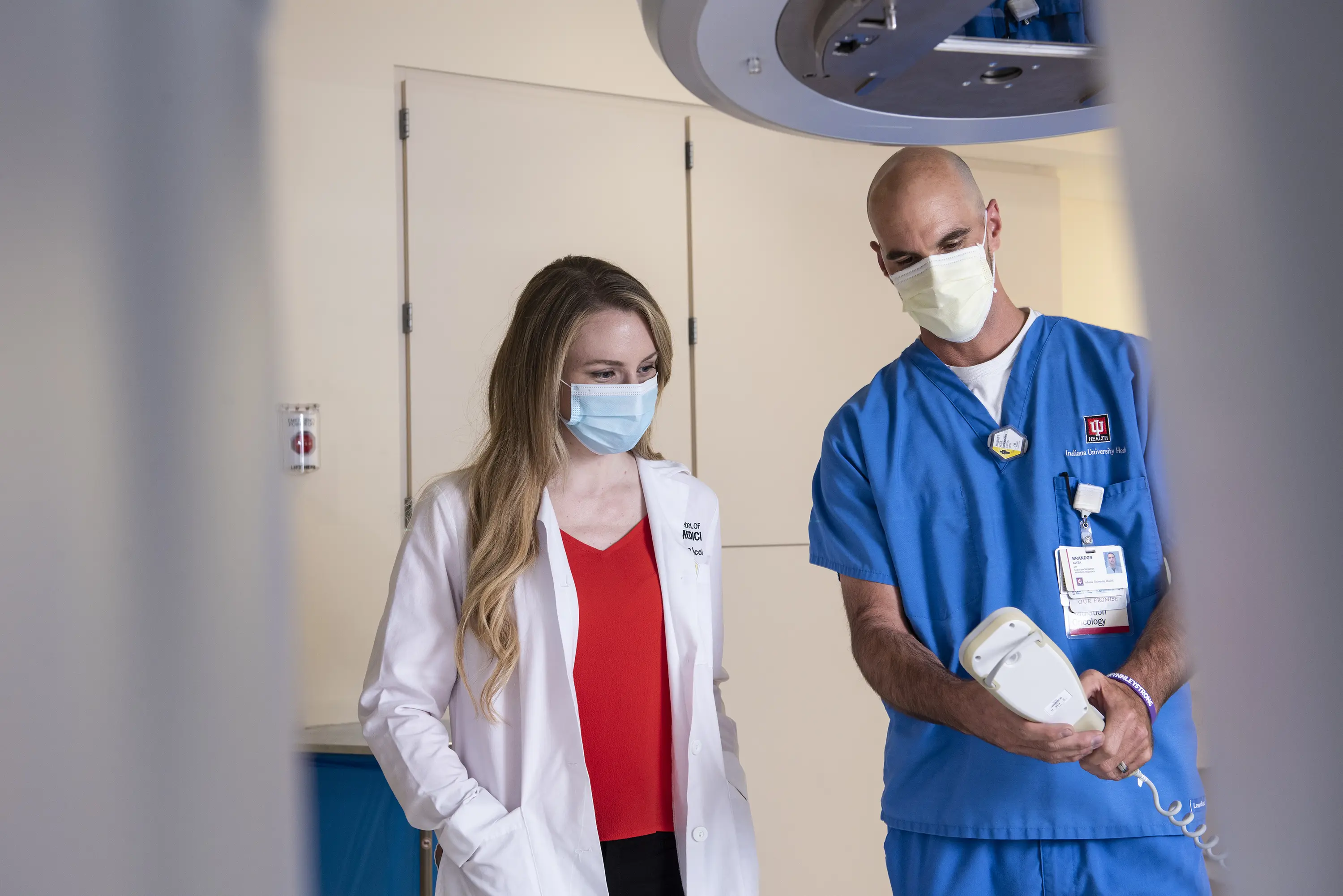 A physician and a radiation therapist work together in the clinic