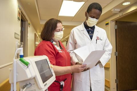 Doctor and Nurse talking in hallway
