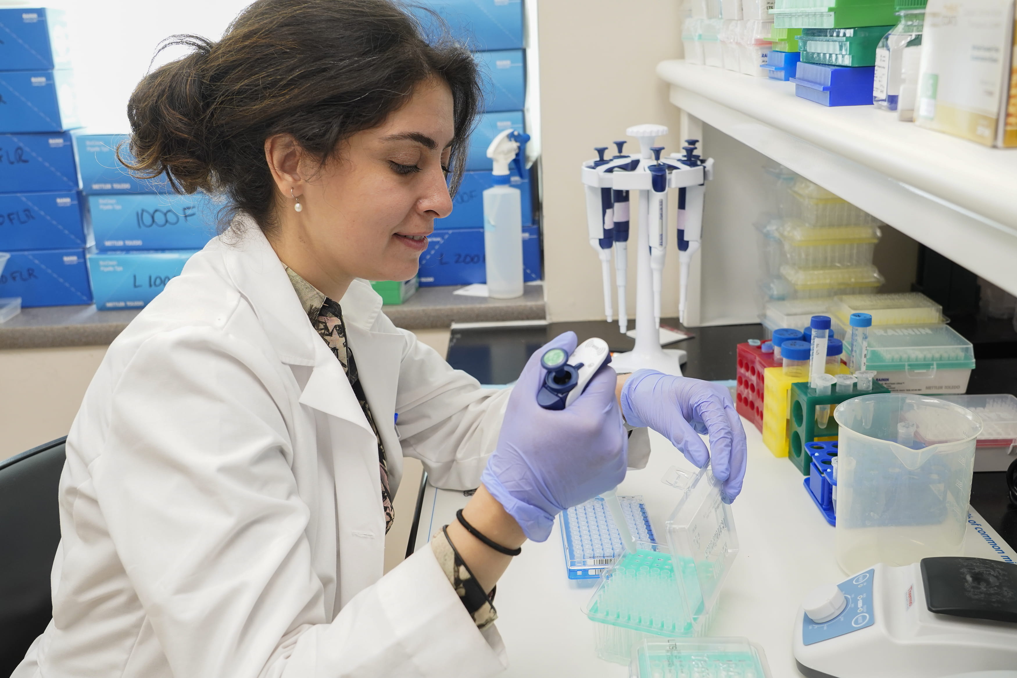 a resident prepares a sample in the lab