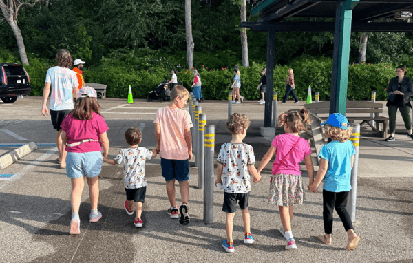 Group of children walking together holding hands