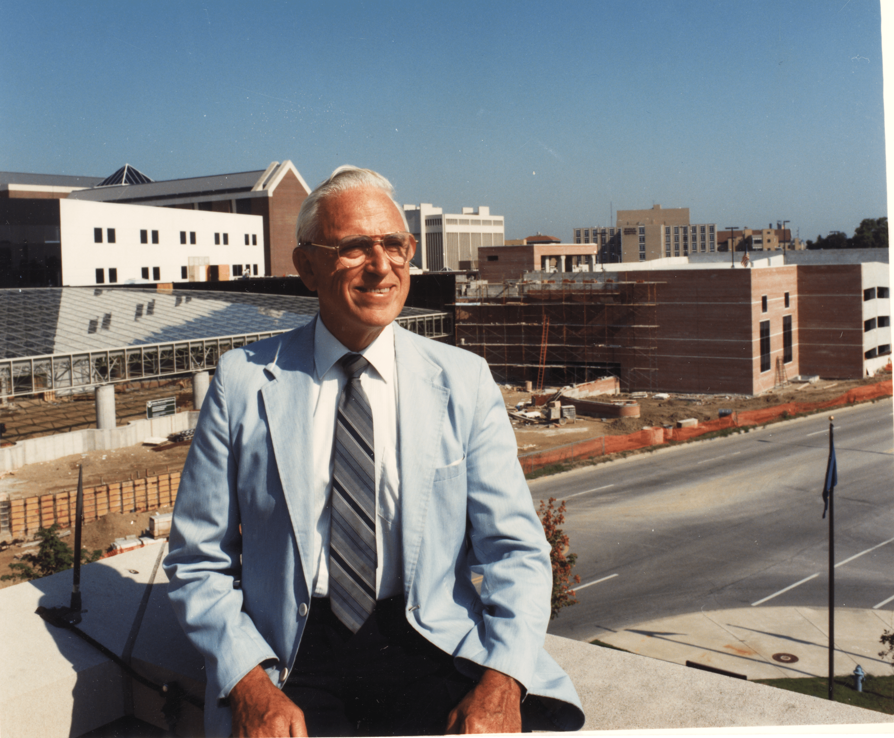 a man in a suit, tie and glasses
