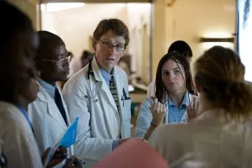 Physician talking with a group of Residents