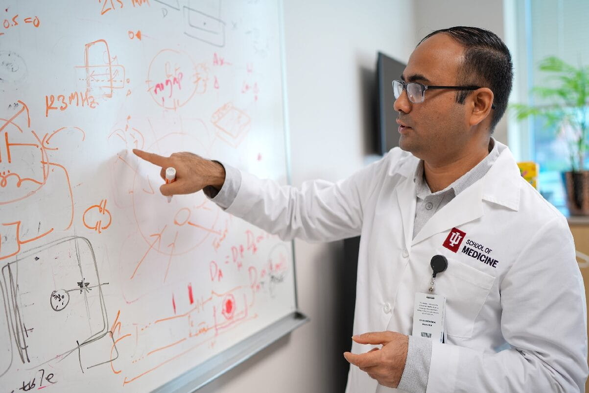 a resident writes on a white board