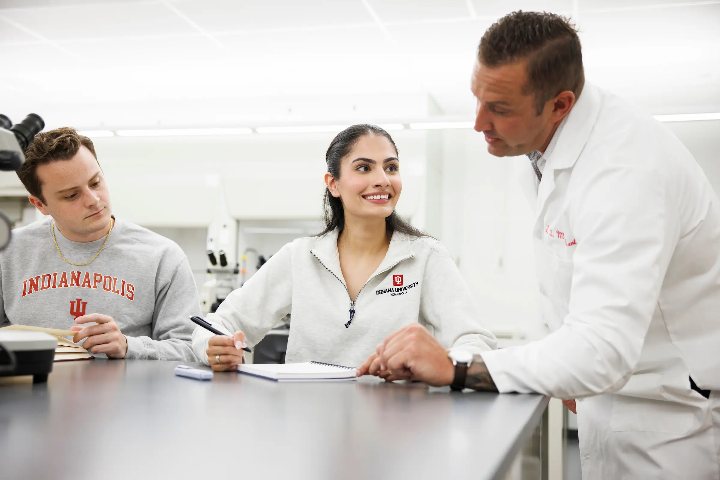 Male physicians teaches two trainees.