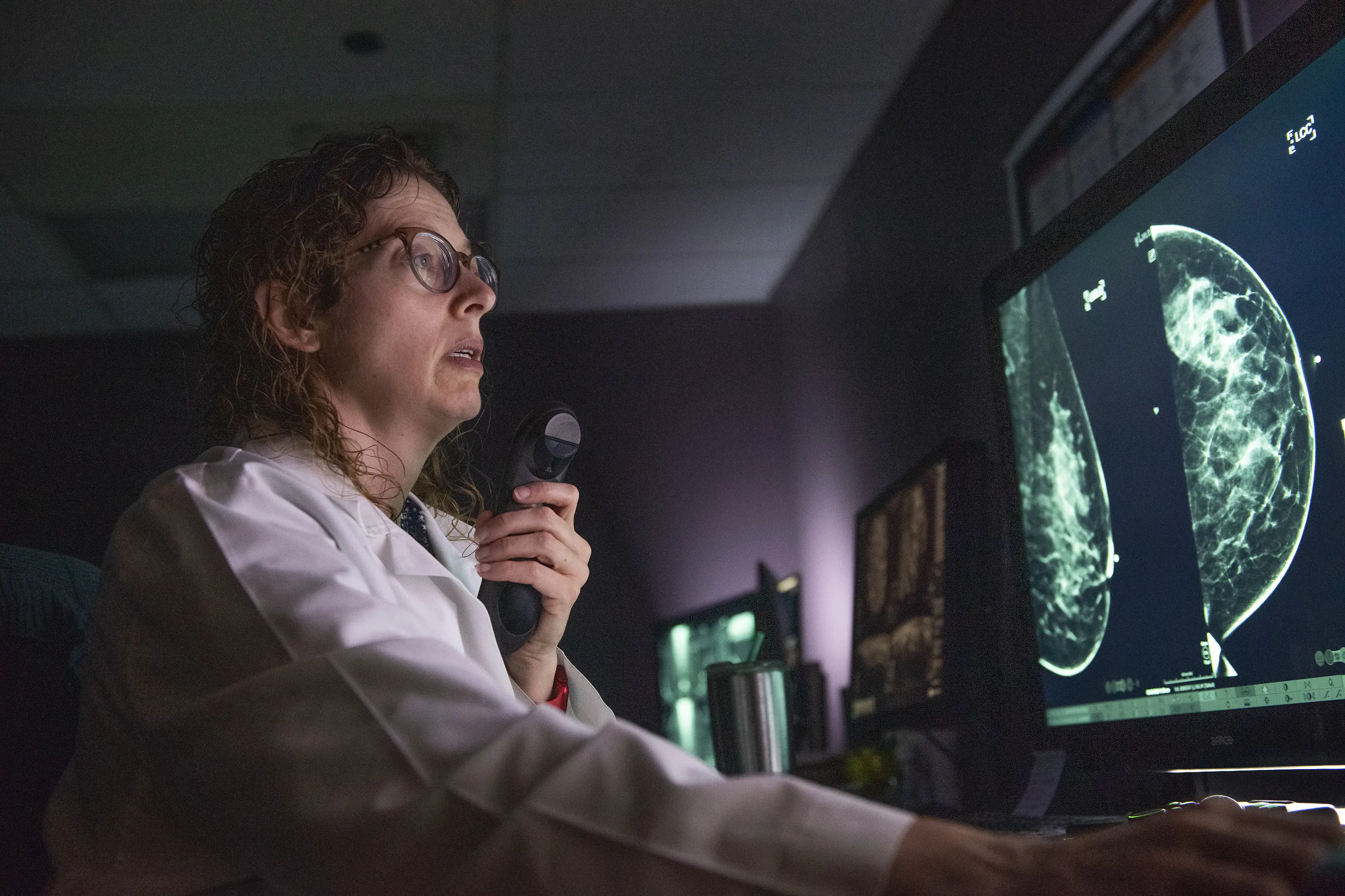 A male radiologist studies images of the head/neck.