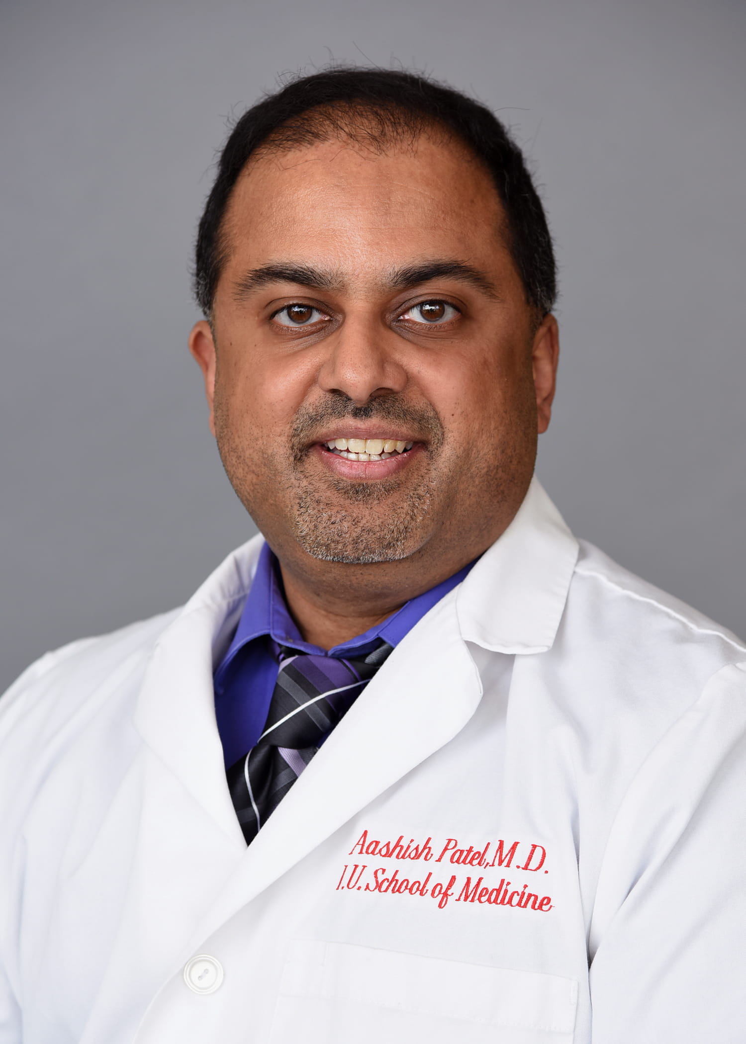 Headshot of Aashish Patel wearing his white coat.