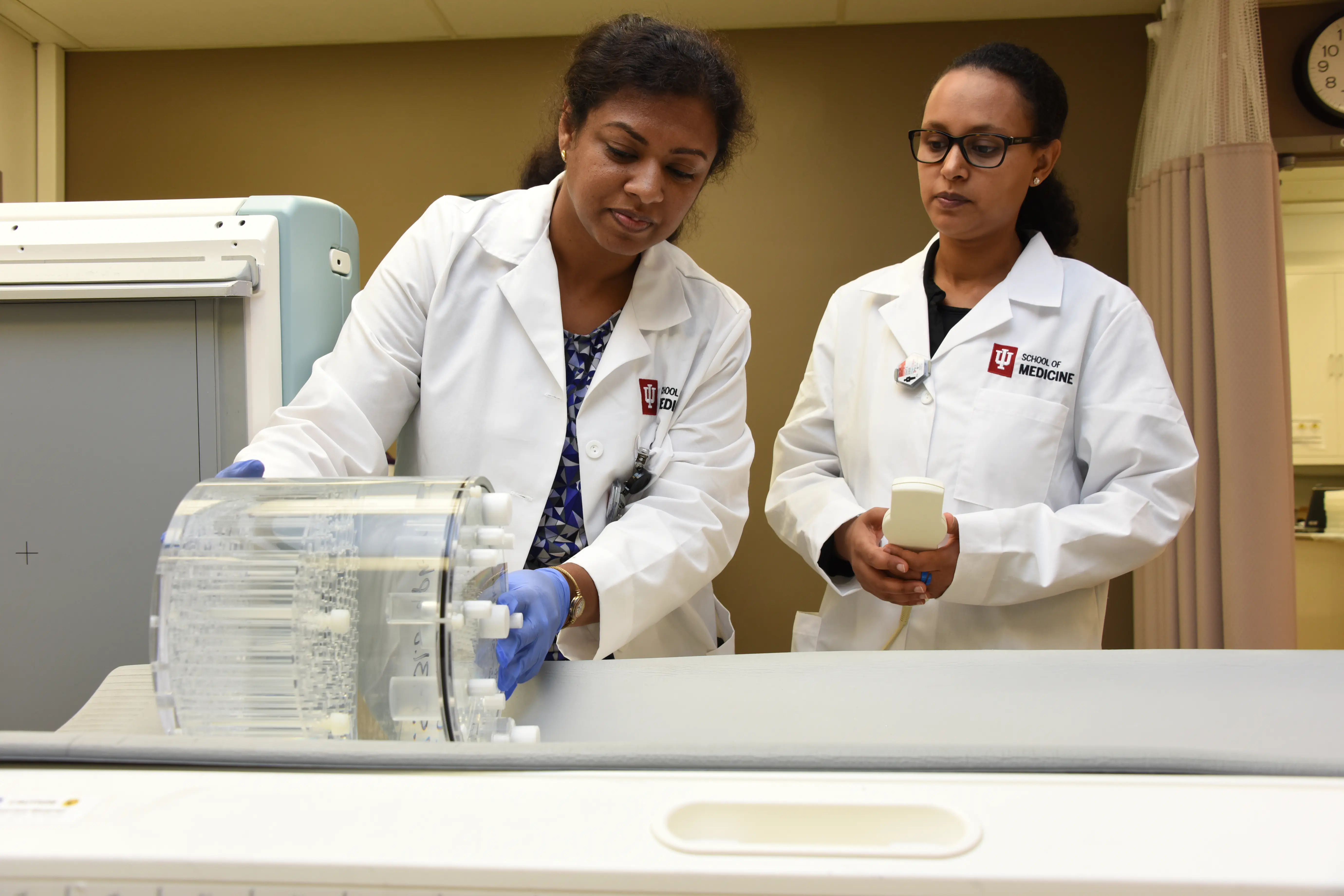 Image of two female researches working.