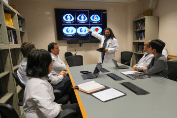 A group of residents study a set of abdominal scans.
