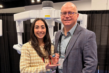 Noosha Deravi, MD, holding an Excellence Coin Award presented by Matt Ritter, MD.