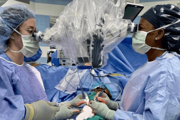 Two women surgeons performing a microsurgery OR case