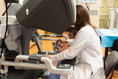 Resident Payton Miller is engaging with the Davinci robotic console.