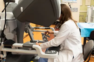 Resident Payton Miller is engaging with the Davinci robotic console.