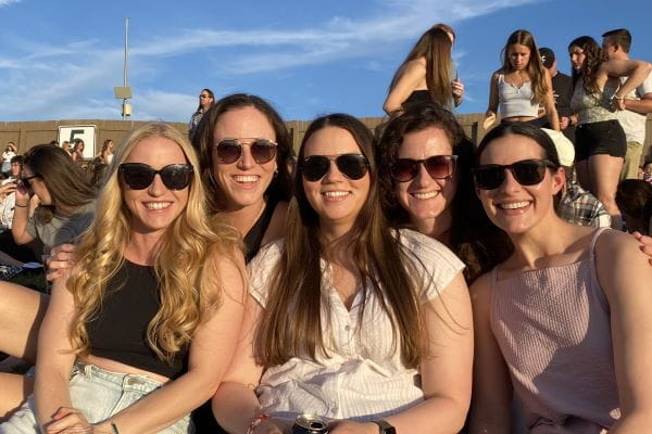 Alexa Hughes, MD, MEd, pictured far left with friends at Ruoff Music Center outdoor concert