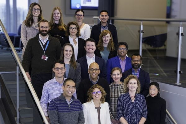 SOQIC team members posing for a group photo on stairs