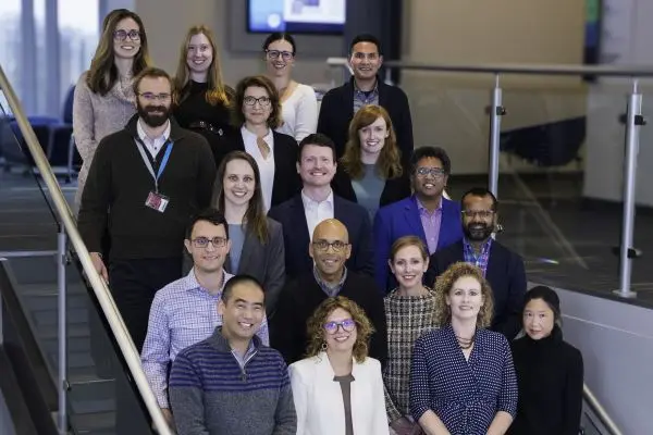 SOQIC team members posing for a group photo on stairs