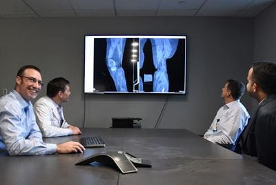 Dr. Roman Natoli with colleagues in orthopaedic surgery orthopedic surgeons reviewing a case together
