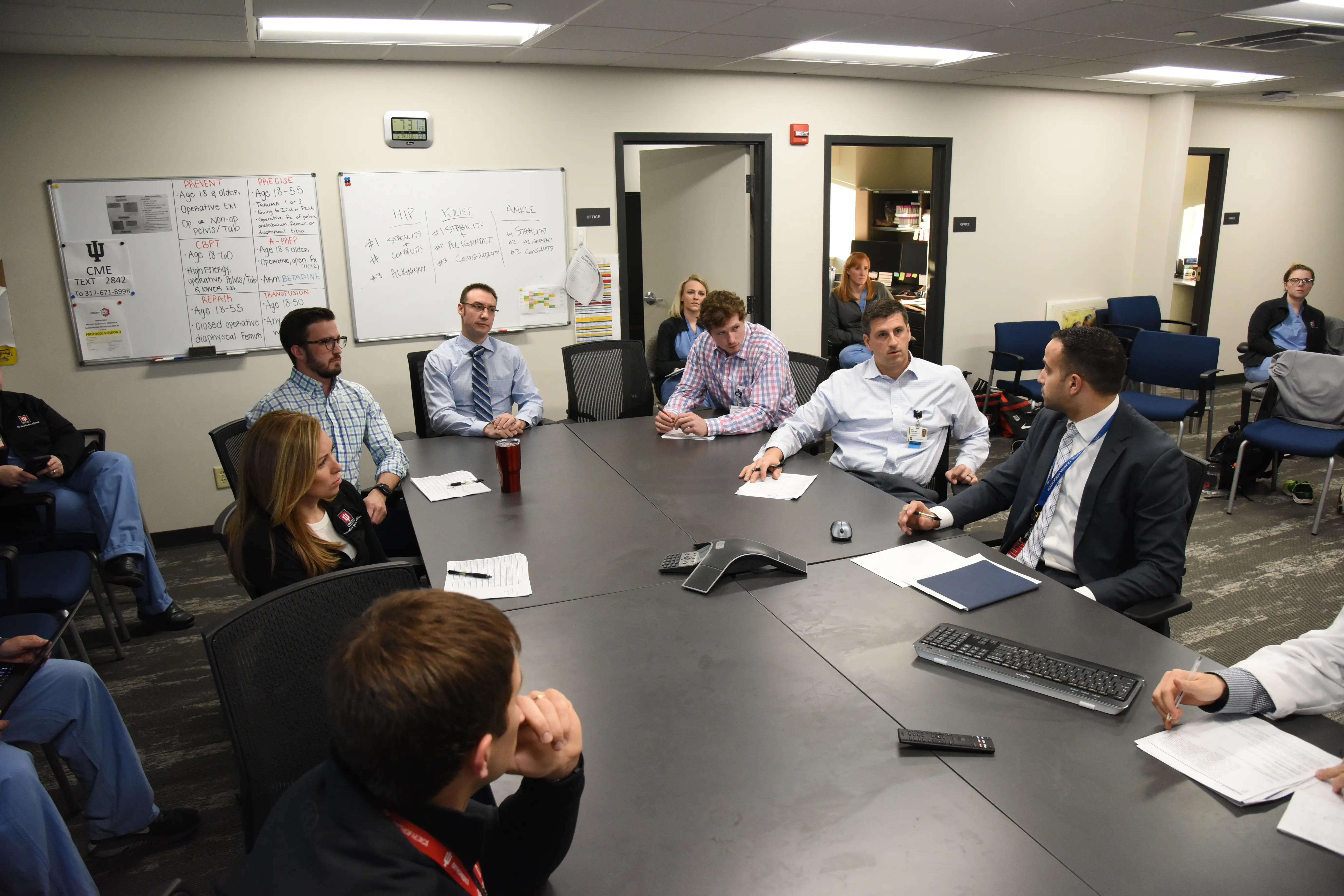 Orthopaedic surgery faculty sit at a large conference table.