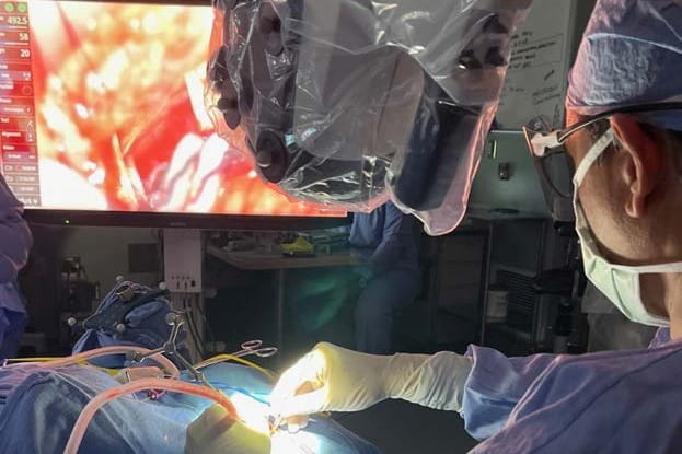 A skull base surgeon operates on a patient