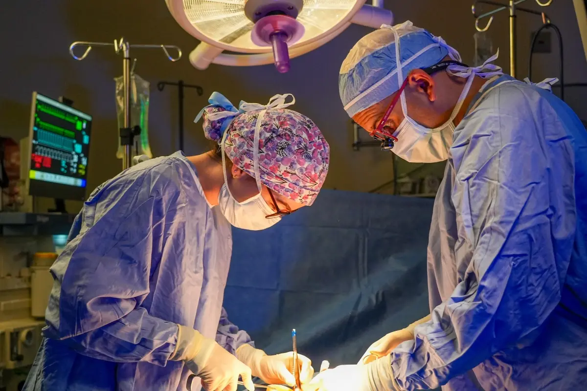 two surgeons focus on their work in the operating room