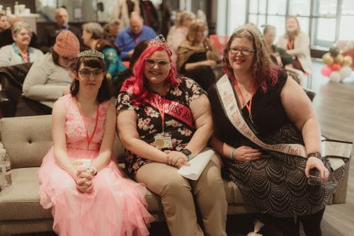 3 women with sitting next to one another