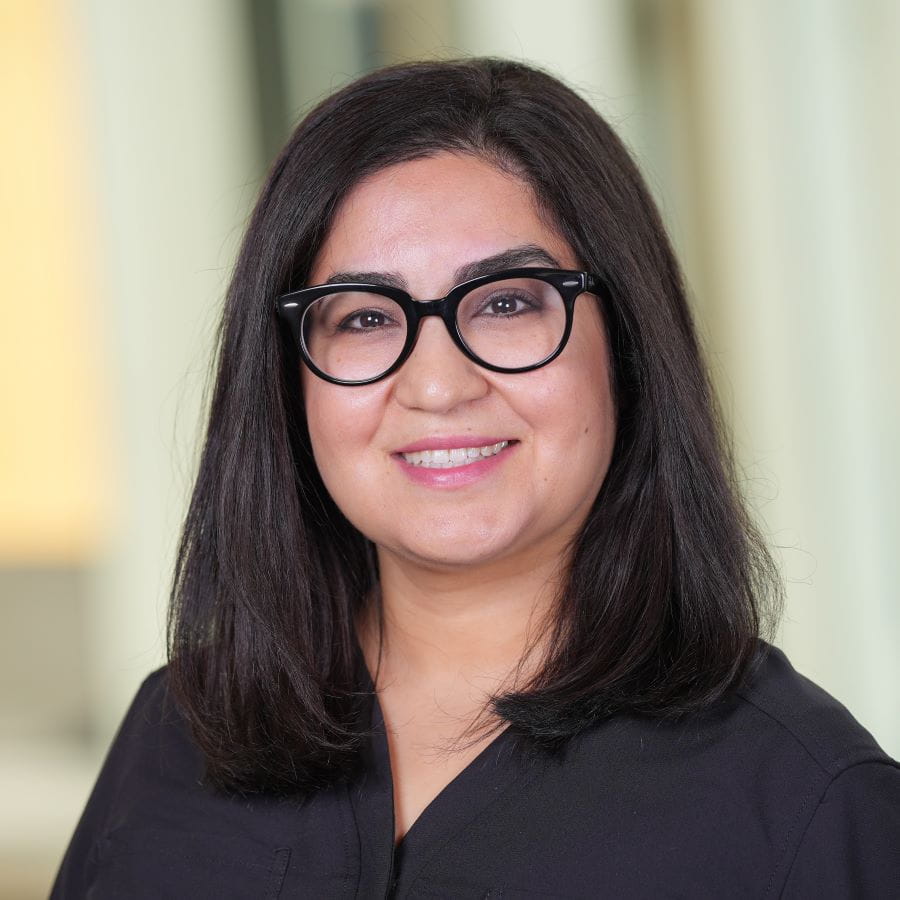 woman with dark hair and glasses