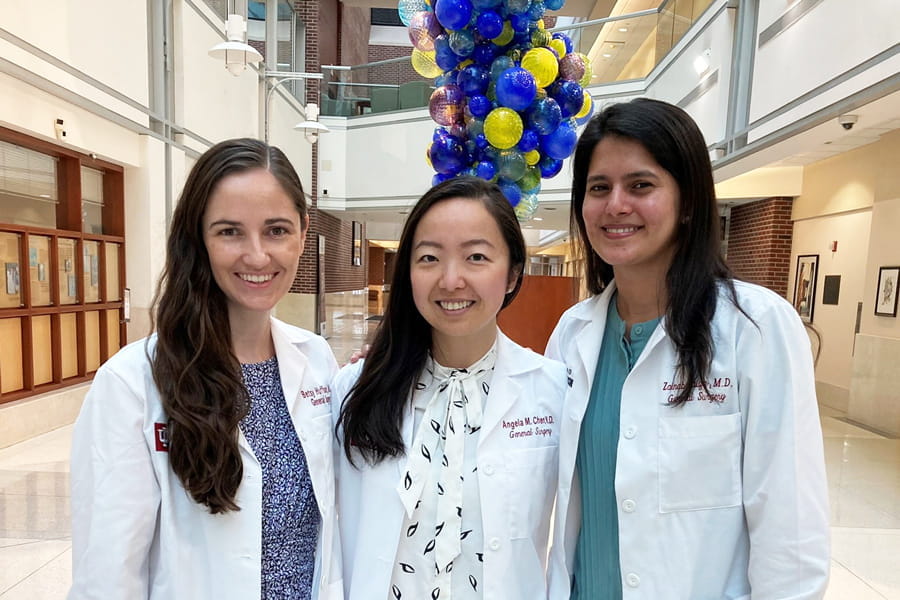 three residents in white coats