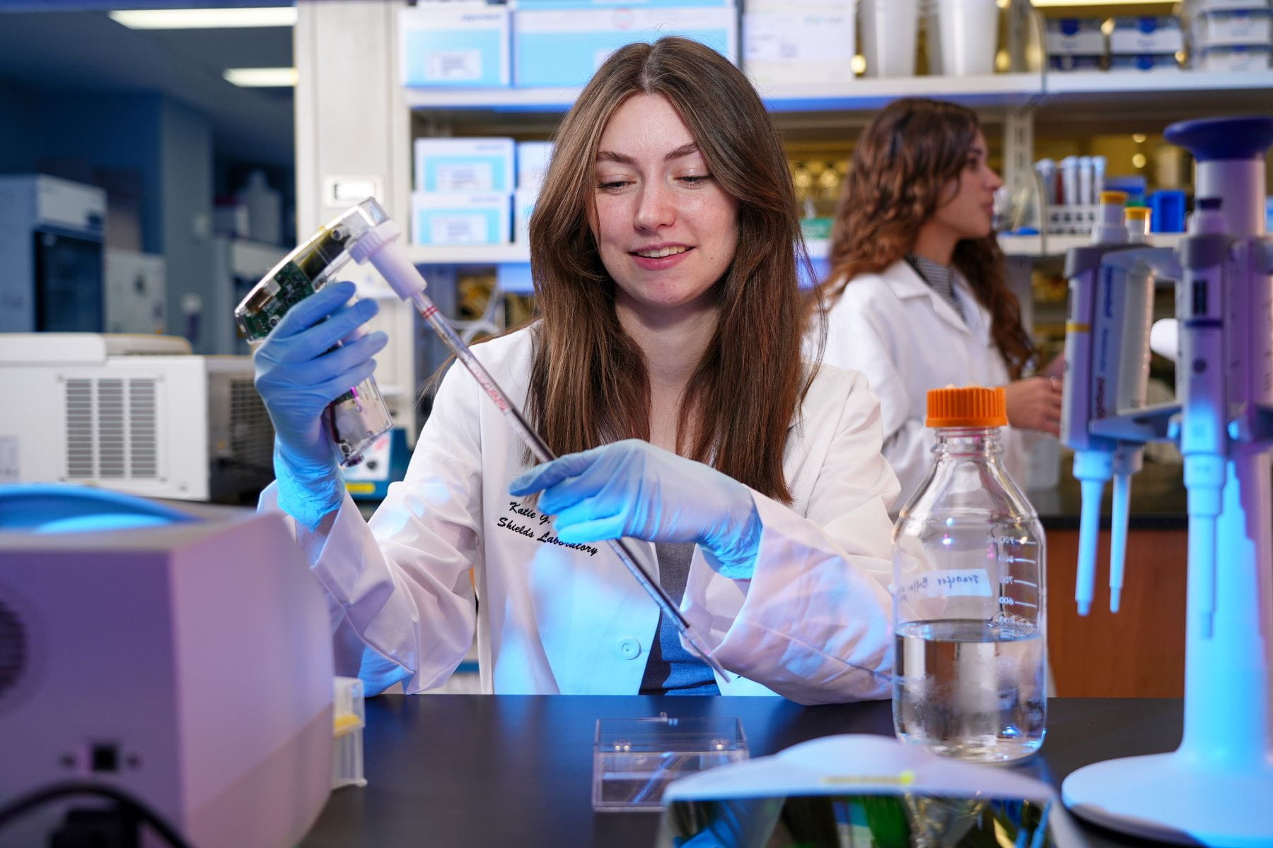 two grad students prepare samples in the lab