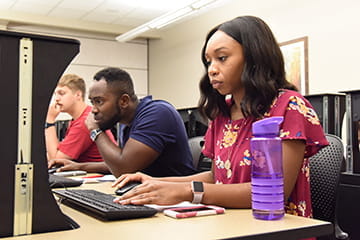 undergraduate students work on computers during class