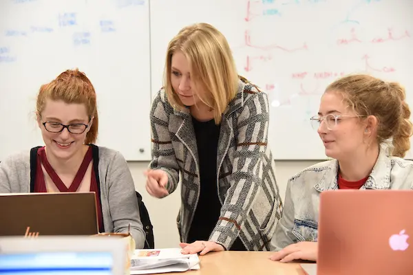 Medical students at the Evansville campus work together reviewing medical literature on a computer during class.