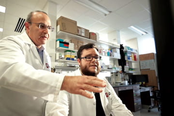 a researcher and lab technician are in the lab
