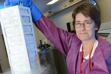 A researcher holds a case of biospecimens