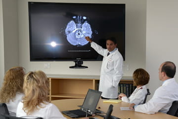 doctors discuss a brain scan in the office