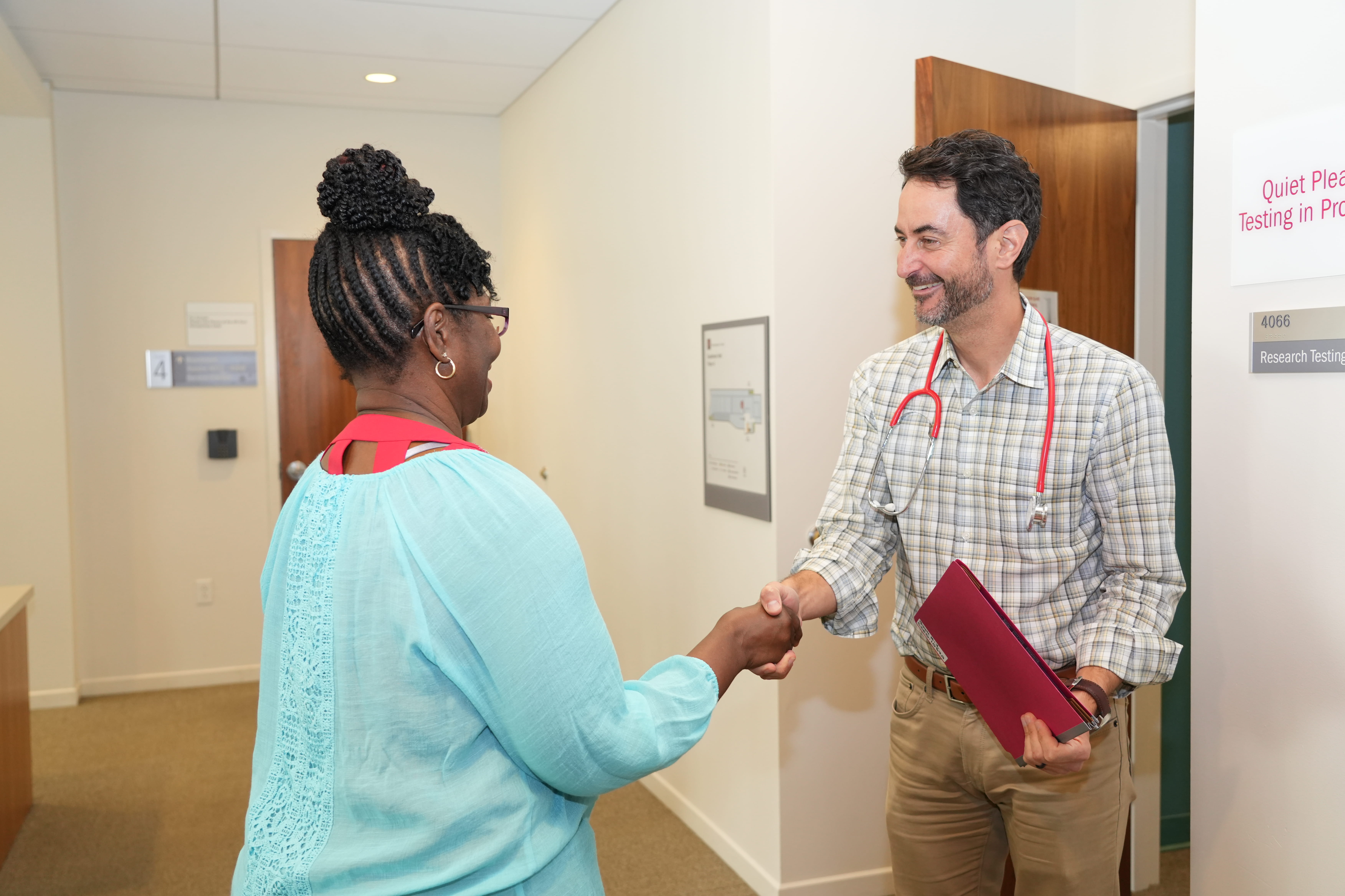 a clinician meets with a clinical trial participant