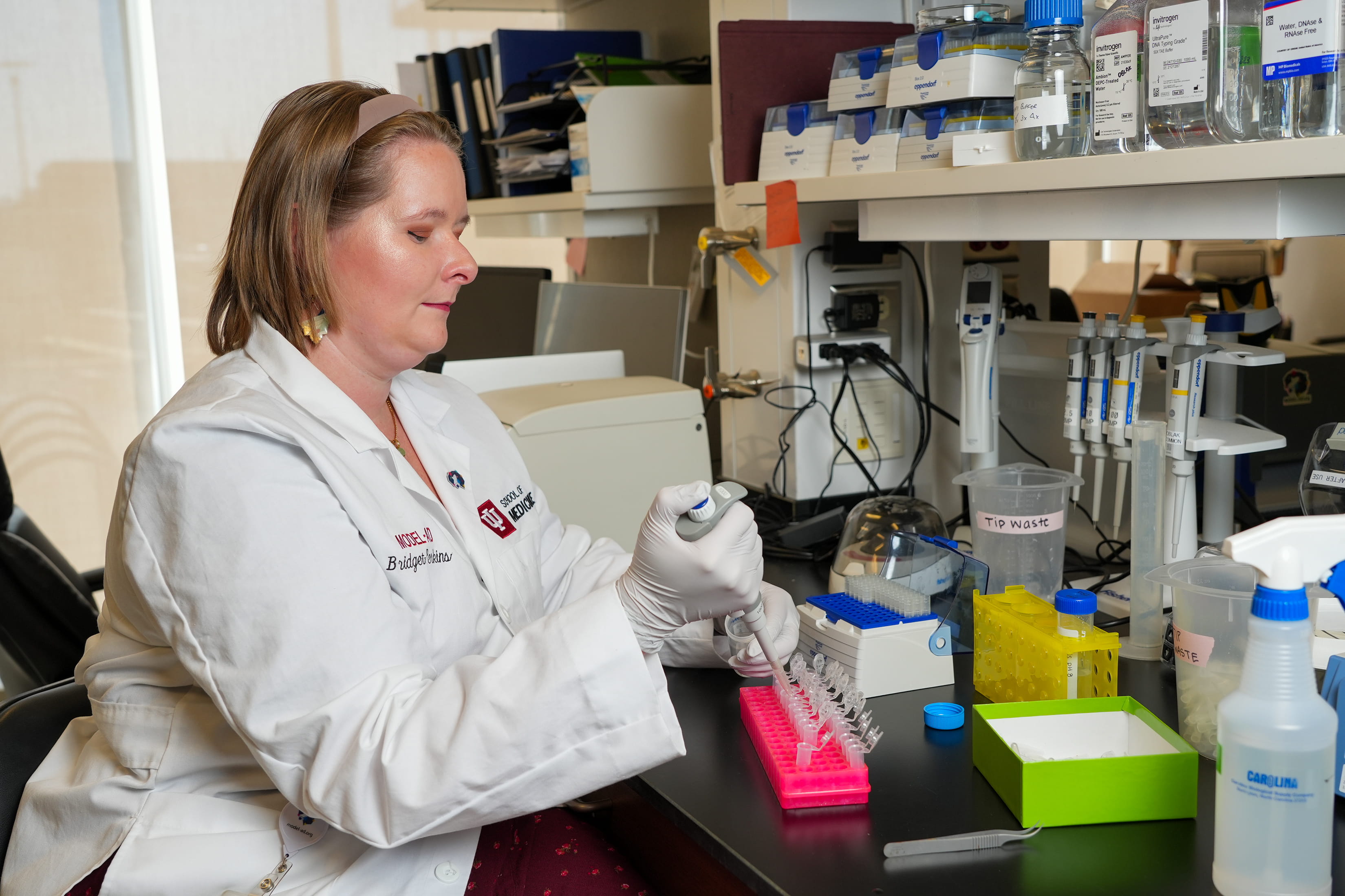a researcher pipets in the lab