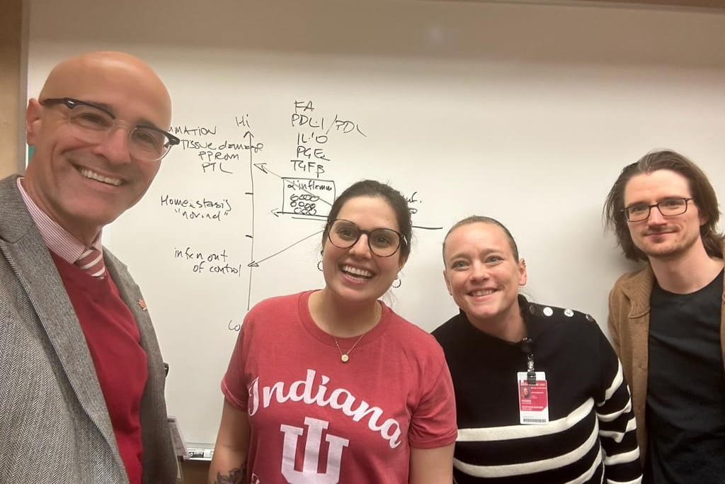 the aronoff lab in front of a white board of notes
