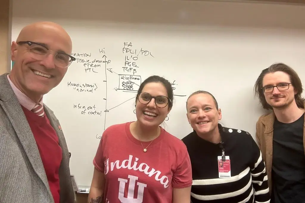 the aronoff lab in front of a white board of notes