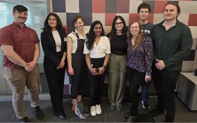 Group photo of 8 people representing the Datta lab.