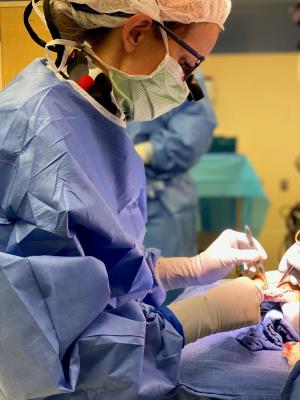 Woman doing surgery on a hand