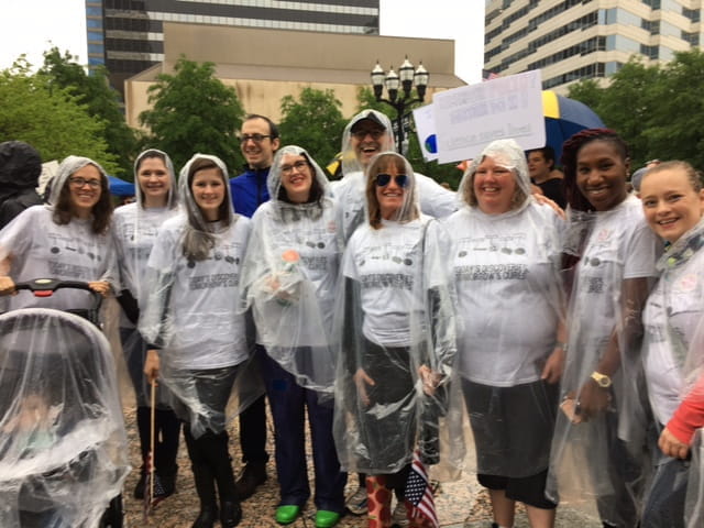 aronoff lab members outside on a rainy day at the March for Science in Nashville in 2017