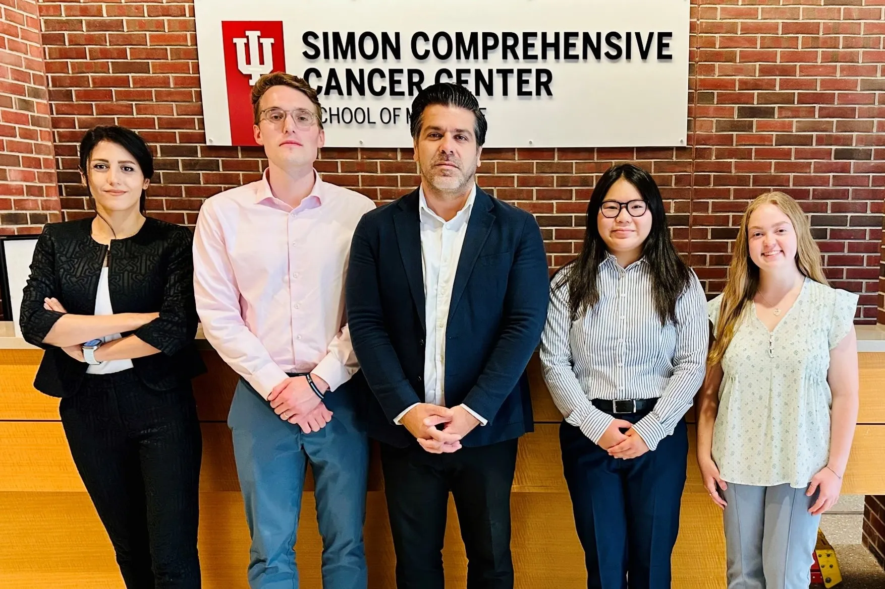members of the shahbazi lab in front of the cancer center