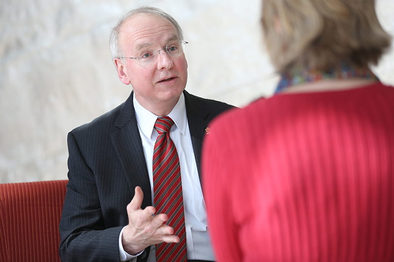 IU School of Medicine Dean Jay Hess, MD, has a conversation with a colleague.
